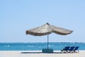 Beach straw umbrella from the sun on the beach with sun beds, on the background of the sea and blue sky, Royalty Free Stock Photo