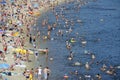 Beach, strong heat. Crowd of people sunbathing and swimming in the water. Hydropark, Kyiv, Ukraine