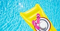 Beach summer holiday background. Inflatable air mattress, flip flops and hat on swimming pool. Yellow lilo and summertime