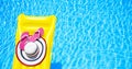 Beach summer holiday background. Inflatable air mattress, flip flops and hat on swimming pool. Yellow lilo and summertime Royalty Free Stock Photo