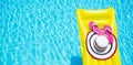 Beach summer holiday background. Inflatable air mattress, flip flops and hat on swimming pool. Yellow lilo and summertime