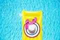 Beach summer holiday background. Inflatable air mattress, flip flops and hat on swimming pool. Yellow lilo and summertime Royalty Free Stock Photo