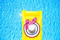 Beach summer holiday background. Inflatable air mattress, flip flops and hat on swimming pool. Yellow lilo and summertime Royalty Free Stock Photo