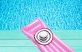 Beach summer holiday background. Inflatable air mattress and hat on blue wooden floor near swimming pool. Pink lilo and summertime Royalty Free Stock Photo