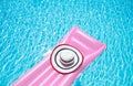 Beach summer holiday background. Inflatable air mattress and hat on swimming pool. Pink lilo and summertime accessories Royalty Free Stock Photo