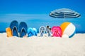 A Beach summer holiday banner background. Flip-flops and hat with a board and ball on the sand near the ocean. Summer accessories Royalty Free Stock Photo