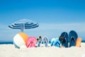 A Beach summer holiday banner background. Flip-flops and hat with a board and ball on the sand near the ocean. Summer accessories Royalty Free Stock Photo