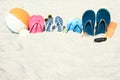 A Beach summer holiday banner background. Flip-flops and hat with a board and ball on the sand near the ocean. Summer accessories Royalty Free Stock Photo