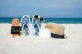 A Beach summer holiday banner background. Flip-flops and hat with a board and ball on the sand near the ocean. Summer accessories Royalty Free Stock Photo