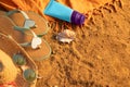 Beach summer holidays by the sea. Means of protection against ultraviolet radiation. Sun Cream jar, hat and glasses. Royalty Free Stock Photo