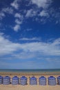 Beach in summer with tents, sun and blue sky Royalty Free Stock Photo