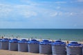 Beach in summer with tents, sun and blue sky Royalty Free Stock Photo