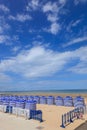 Beach in summer with tents, sun and blue sky Royalty Free Stock Photo