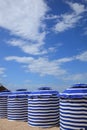 Beach in summer with tents, sun and blue sky Royalty Free Stock Photo