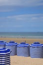 Beach in summer with tents, sun and blue sky Royalty Free Stock Photo