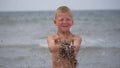 Beach summer vacation. Children's emotions. The child develops tinsel in the wind.