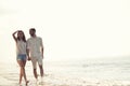 Happy fun beach vacations couple walking together laughing having fun on travel destination. Royalty Free Stock Photo