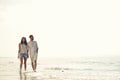 Happy fun beach vacations couple walking together laughing having fun on travel destination. Royalty Free Stock Photo