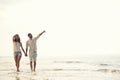 Happy fun beach vacations couple walking together laughing having fun on travel destination. Royalty Free Stock Photo