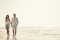 Happy fun beach vacations couple walking together laughing having fun on travel destination. Royalty Free Stock Photo