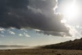 Beach with sun and storm Royalty Free Stock Photo