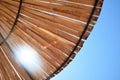 Beach sun umbrella made of bamboo with sunbeam