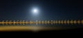 Beach with sunbeds and parasols at night