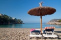 Beach sunbeds with towels and umbrella