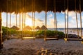 A beach sunrise through a cabana`s hanging swings. Royalty Free Stock Photo