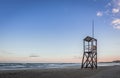 Beach sunrise with lifeguard wooden tower