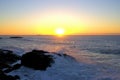 Beach Sunrise Waves hitting rocks Royalty Free Stock Photo