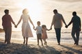 Beach, sunset and back of family holding hands in nature for travel, bond and fun together. Rear view, love and children Royalty Free Stock Photo