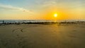 A beach with a sunset in the background Royalty Free Stock Photo