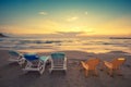 Beach at sunset with chaise lounges