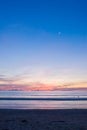 Beach sunset with a half-moon