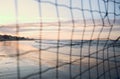 Beach at sunset seen through the net