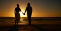 Beach, sunset and a silhouette couple holding hands on vacation or holiday outdoor. Behind man and woman in nature with Royalty Free Stock Photo