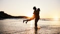 Beach sunset, silhouette and couple hug, celebrate and enjoy romantic time together, bonding and relax in sea water Royalty Free Stock Photo