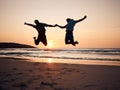 Beach, sunset and silhouette of couple jump, holding hands and enjoy fun quality time together on summer holiday. Energy Royalty Free Stock Photo