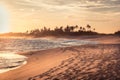 Beach sunset travel vacation lifestyle landscape with palm trees wide sand coastline waves with scenic orange sunset sky in Sri La Royalty Free Stock Photo