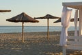 Beach at sunset. Beach umbrellas and tents against the backdrop of the beautiful Black Sea Royalty Free Stock Photo