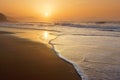 Beach at sunset with wave foam