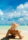 Beach suntan vacation bikini woman lying down tanning under tropical sun in Caribbean. Royalty Free Stock Photo