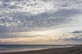 Beach surrounded by the sea under a cloudy sky in the evening - cool for wallpapers