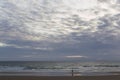 Beach surrounded by the sea under a cloudy sky in the evening - cool for wallpapers