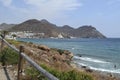 Beach of the town San JosÃÂ© in Cabo de Gata with the mountains in the background and a fence in the foreground Royalty Free Stock Photo