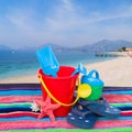 Beach toys with flip flops and starfish on towel Royalty Free Stock Photo