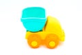 Beach toys: yellow plastic truck with blue trolley on white background Royalty Free Stock Photo