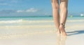Beach travel concept. Sexy Legs on Tropical Sand Beach. Walking Female Feet. Closeup Royalty Free Stock Photo