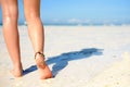 Beach travel concept. Legs on Tropical Sand Beach. Walking Female Feet. Closeup Royalty Free Stock Photo